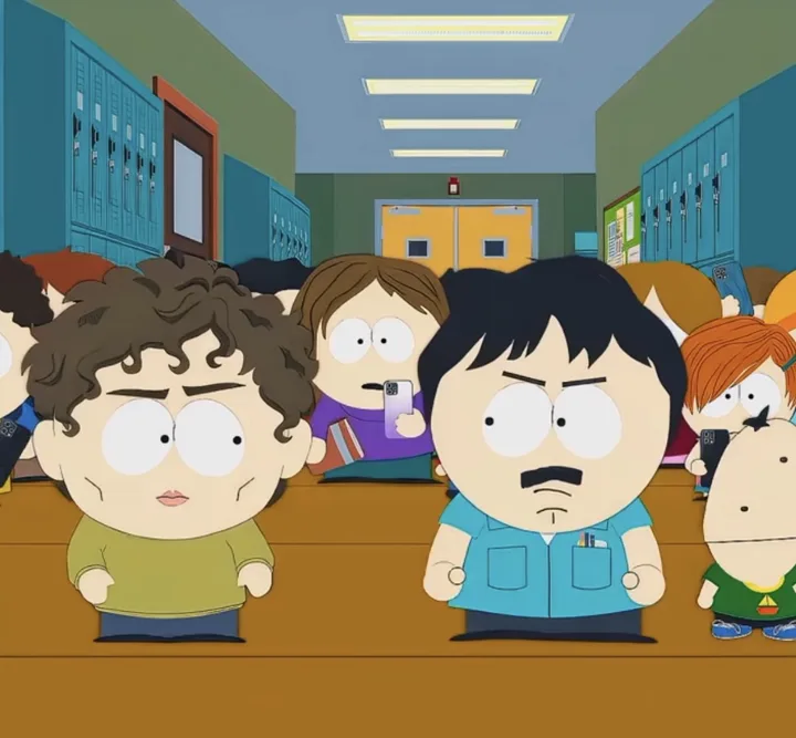 Randy facing the school Chad in a hallway full of kids filming on their phones